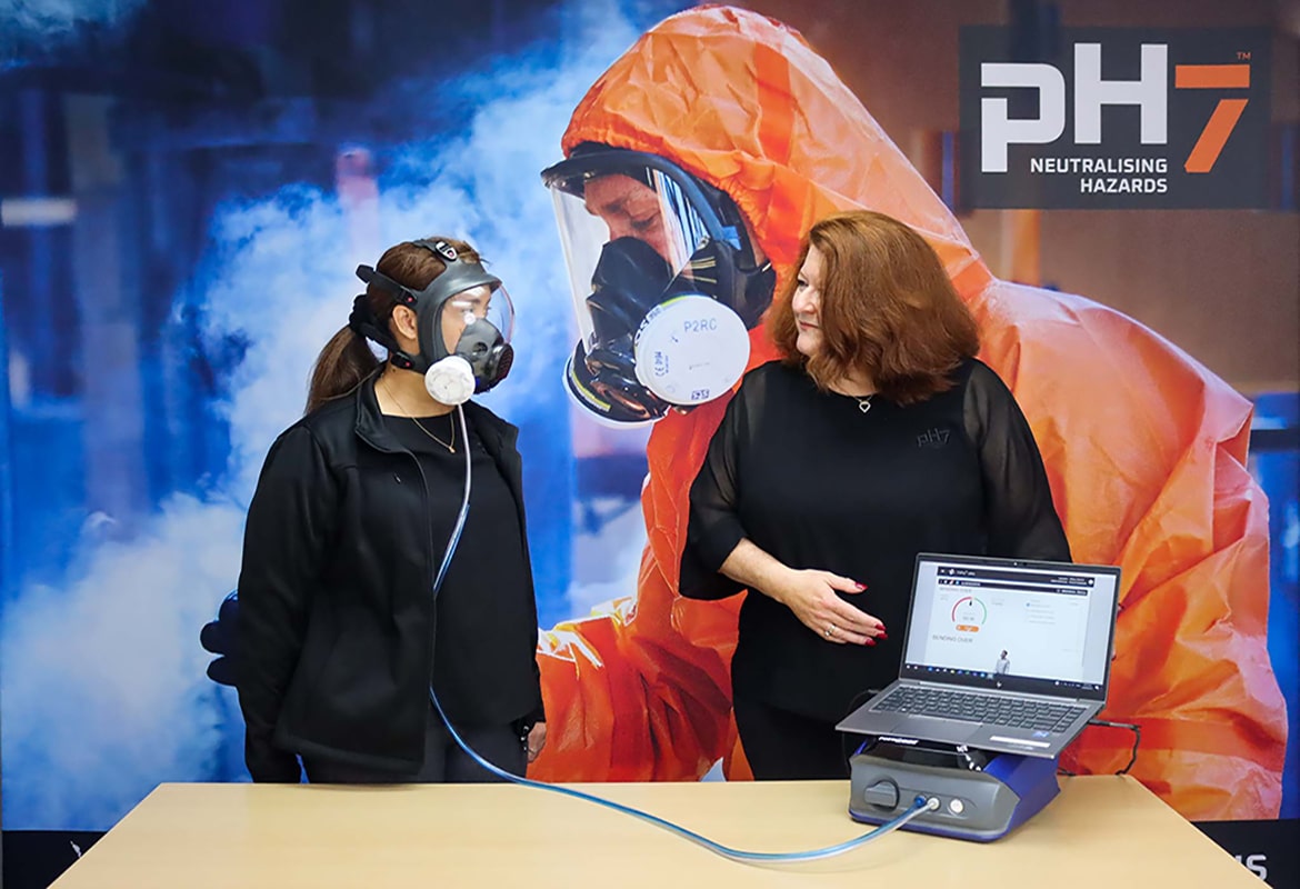 Person performing a respirator fit test on another person