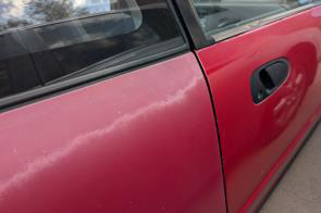 Blended edge sun fade on a red car door