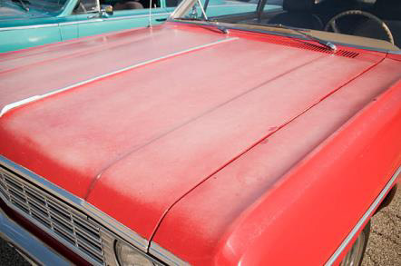 Sun fade on a red car bonnet
