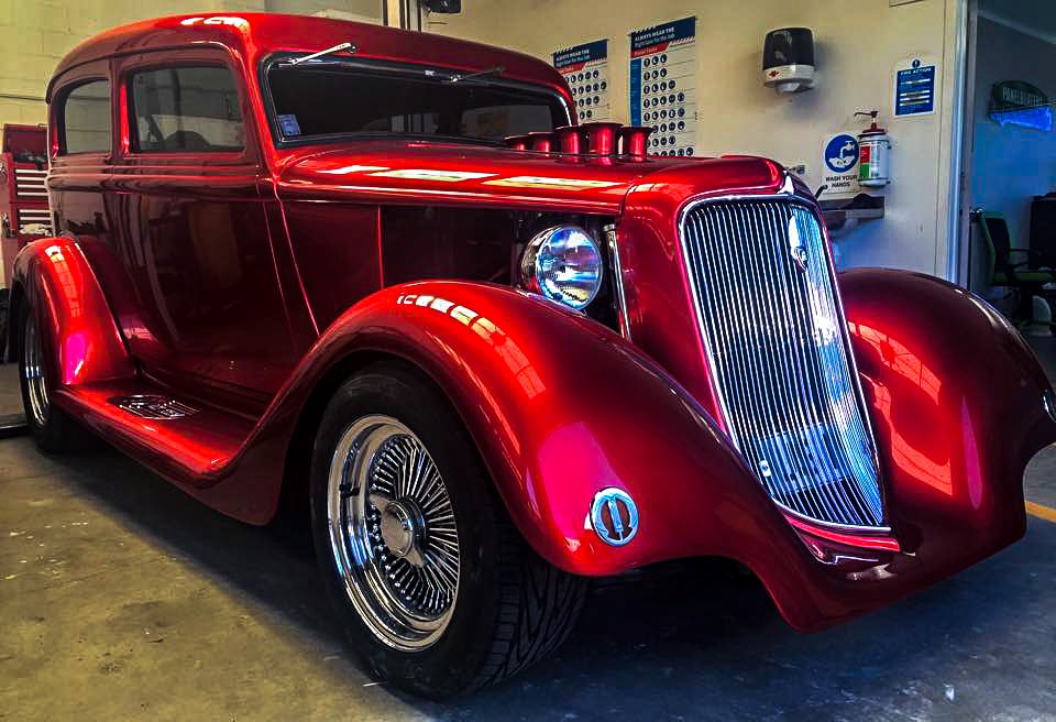 Picture of a vintage car painted in DNA candy red.