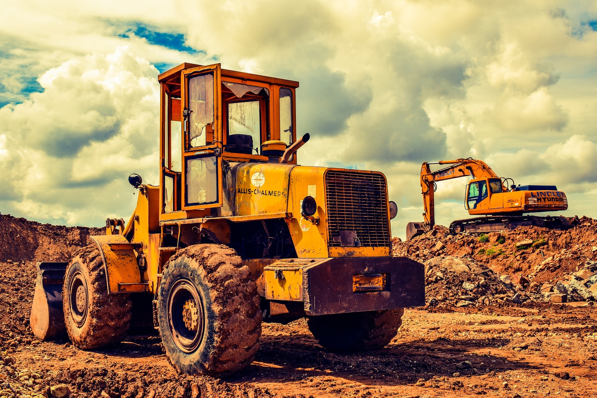 Picture of an industrial dozer and digger working with soil. Used as a background image for the page element.